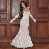 Bride wearing a long sleeve mermaid lace wedding dress with a square neckline.